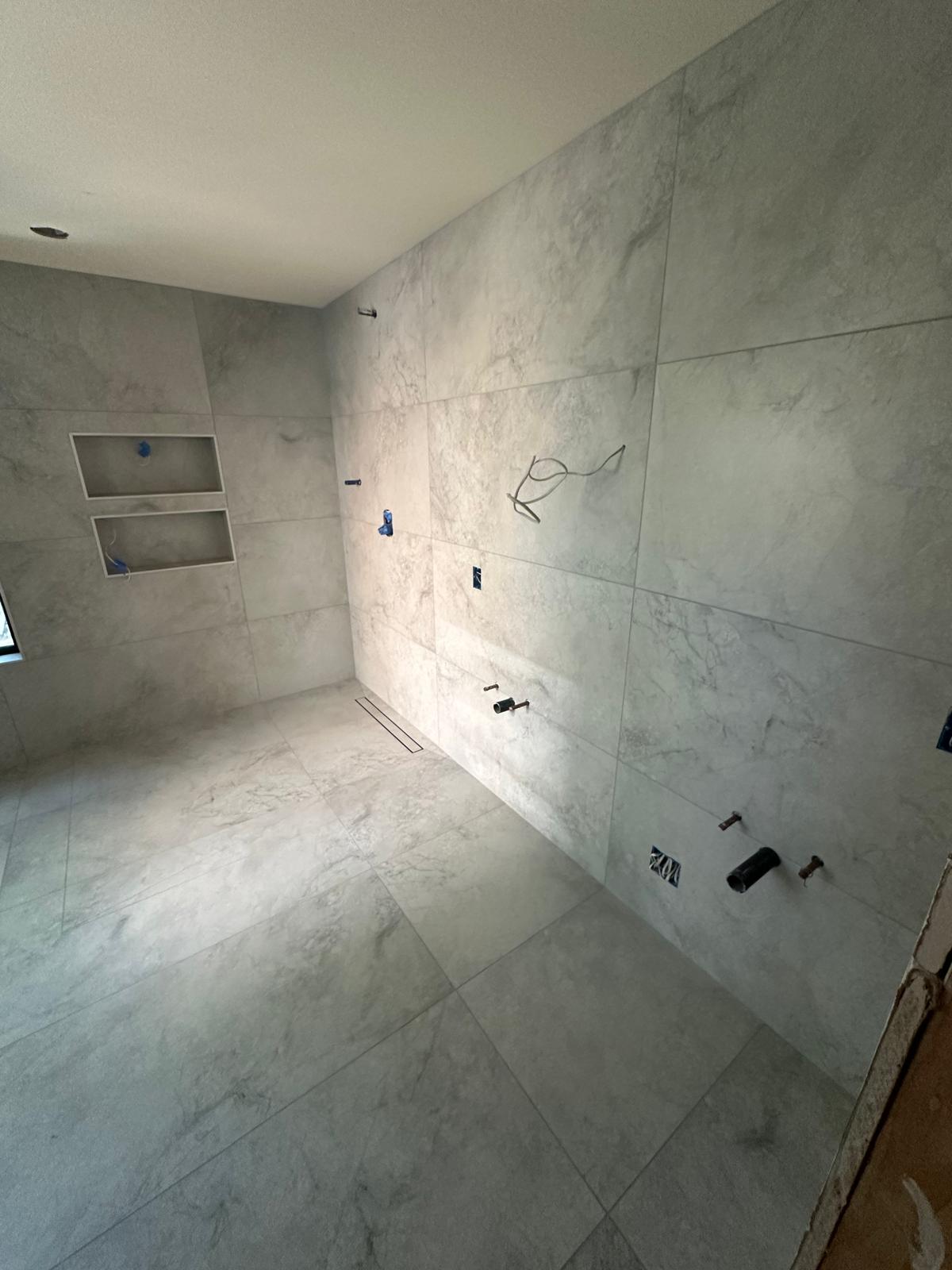 Bathroom remodel - large-format marble tile installed
